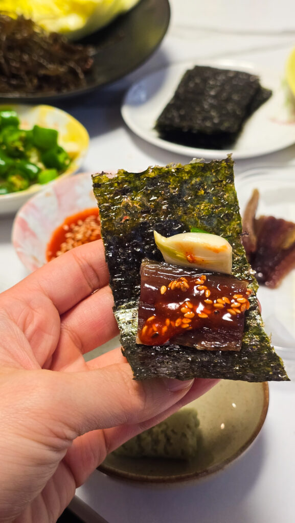 Gwamegi with garlic, chojang, and chili peppers, wrapped in seaweed.
